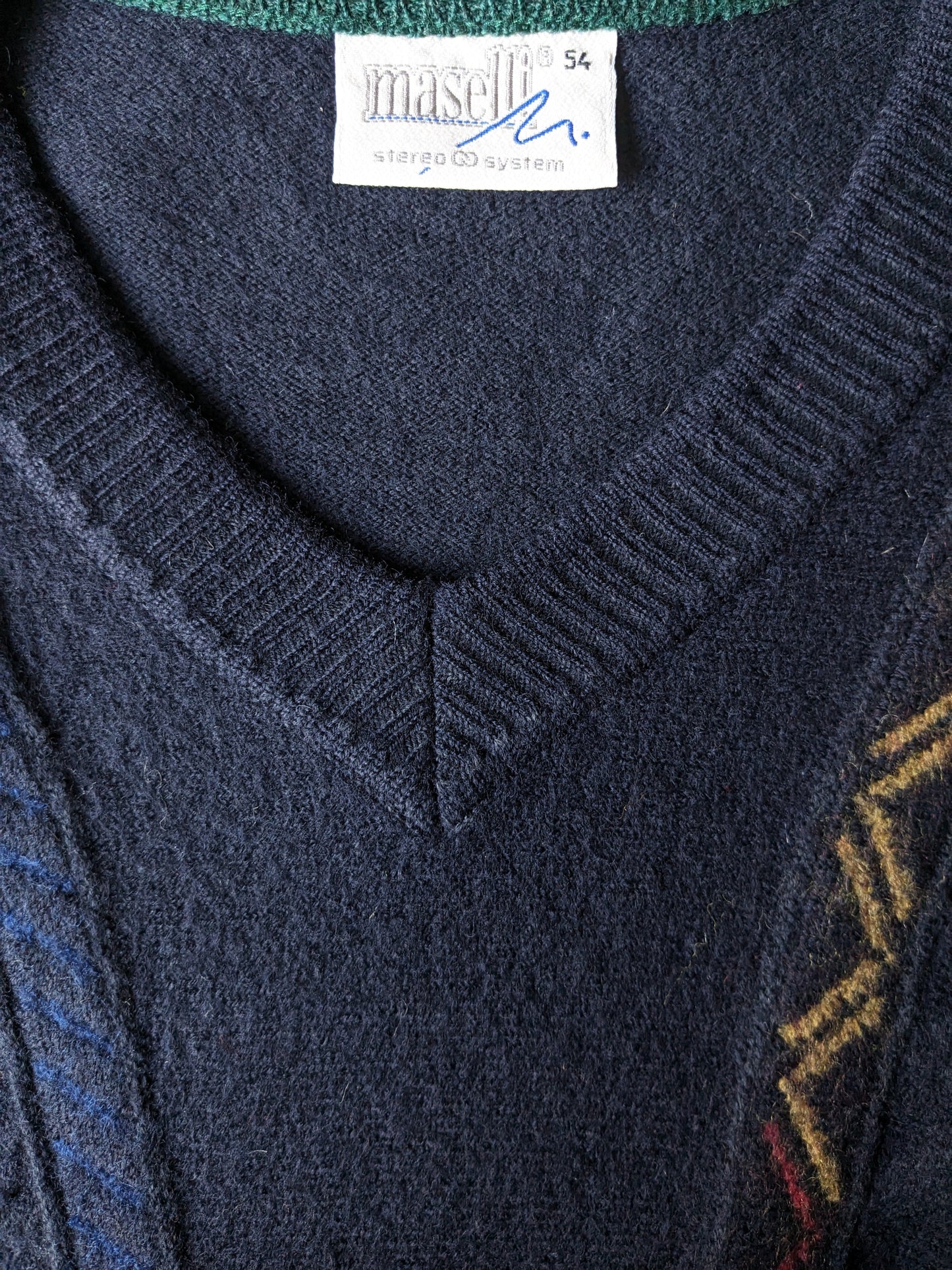 Suéter de lana Maselli Vintage con cuello en V. Azul oscuro con motivo de azul verde rojo amarillo. Talla L.