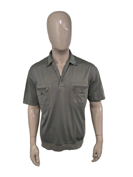 Roger has vintage polo with elastic band. Colored green. Size L.