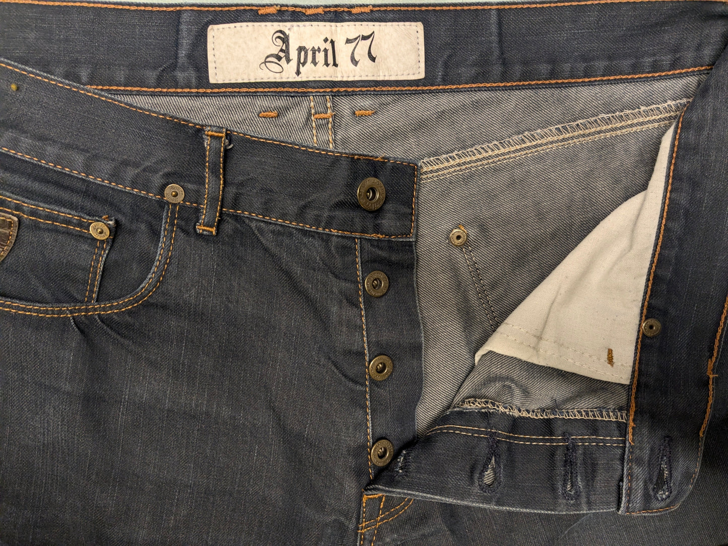 April 77 jeans. Blauw gekleurd met bruine stiksels. Maat W34 - L34.