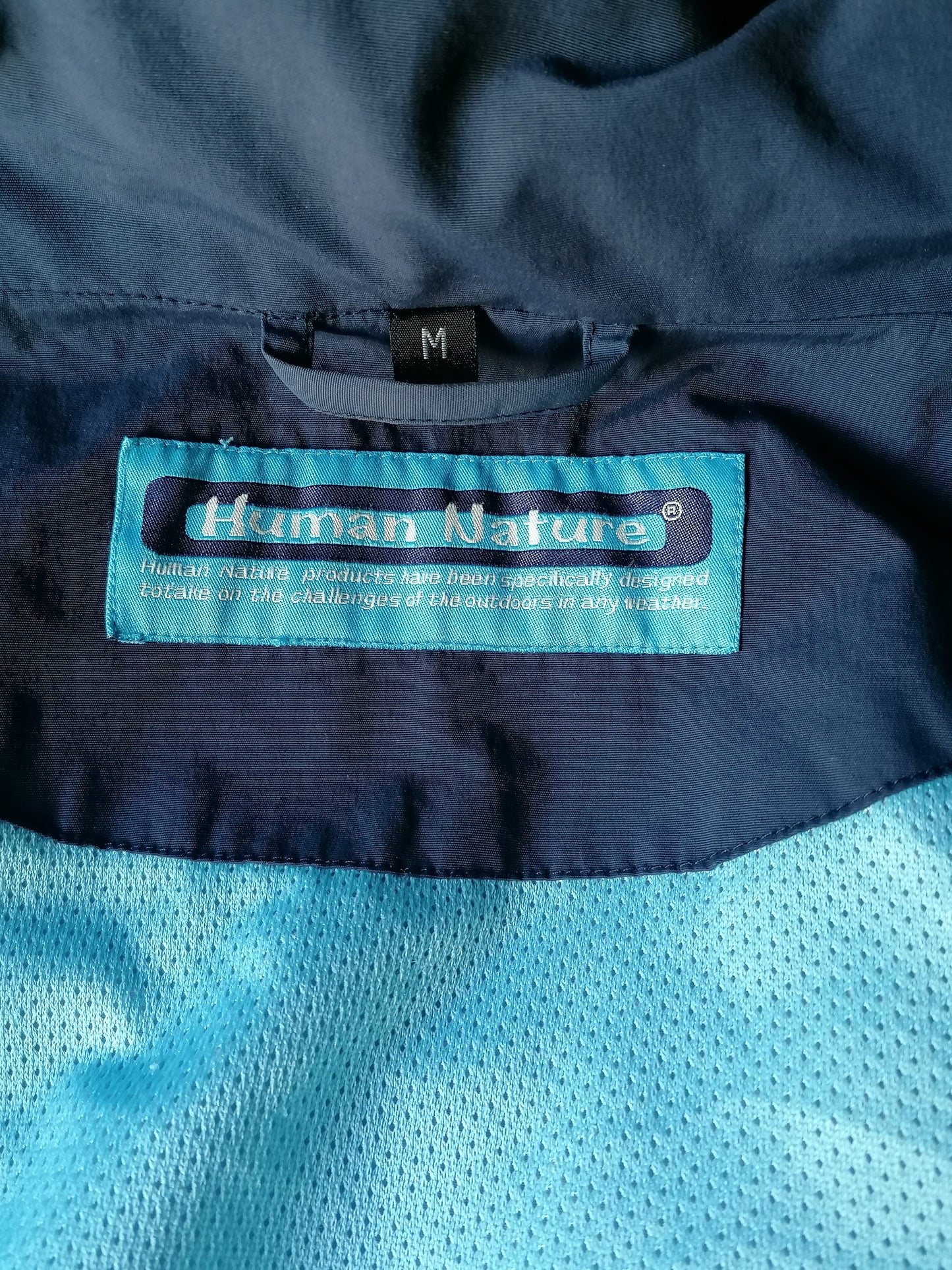 Human Nature between jacket. Dark blue colored. Size M. Ripping hood.