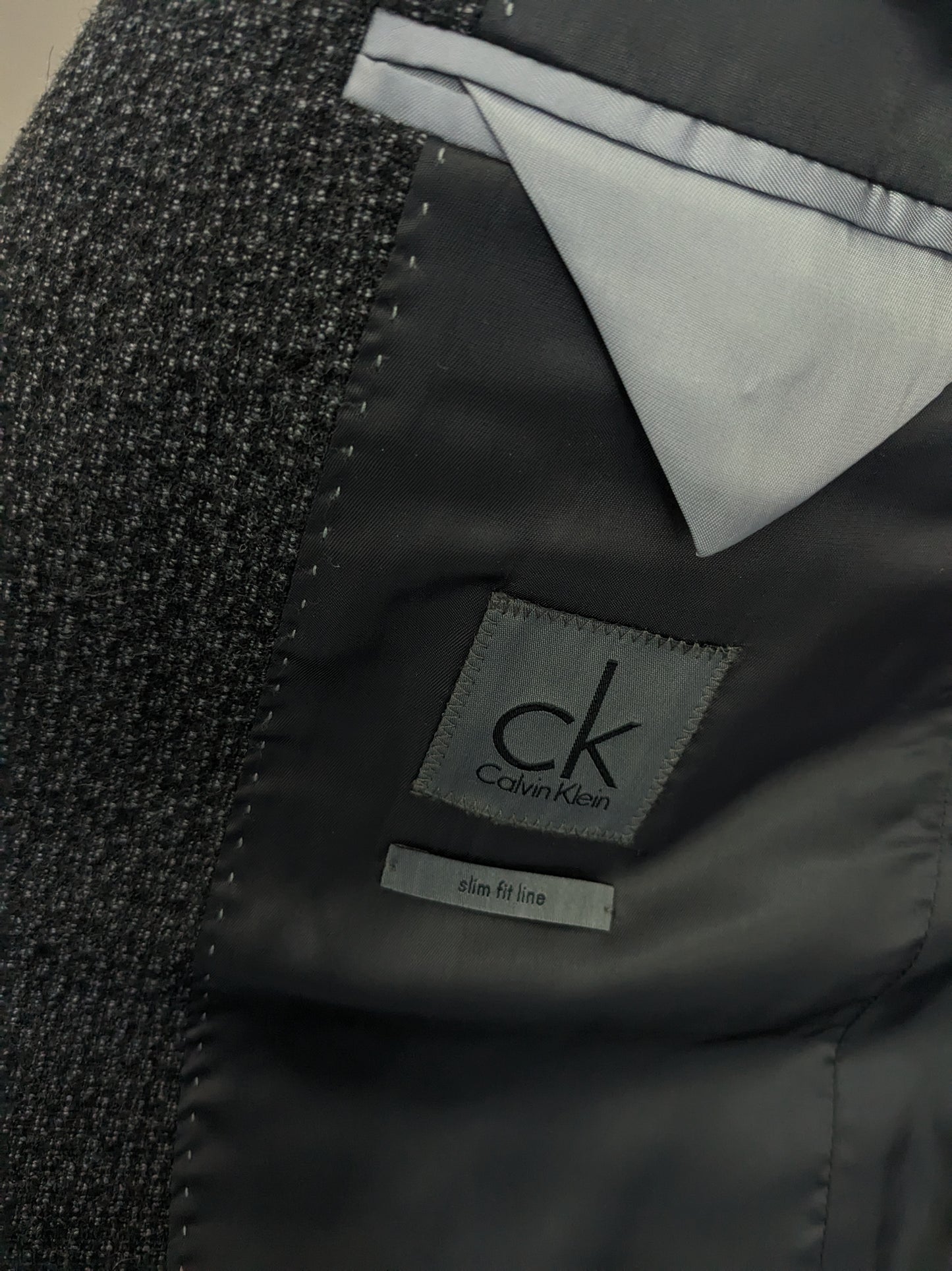 Giacca di lana Calvin Klein CK. Motivo misto nero grigio. Dimensione 50 / M. Slim Fit Line.