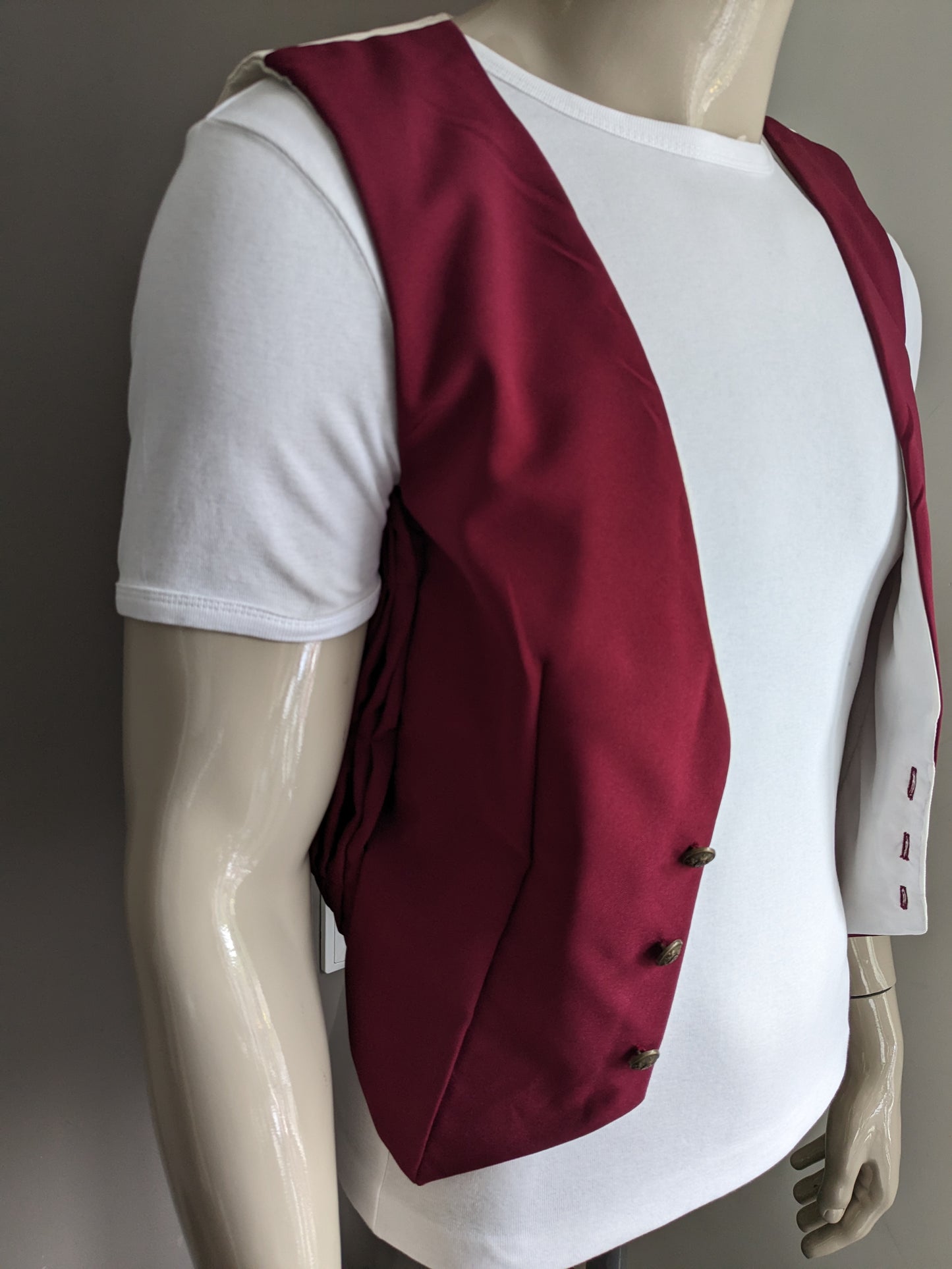 Vintage waistcoat. Bordeaux colored with beautiful buttons and unique sides. Size XS.