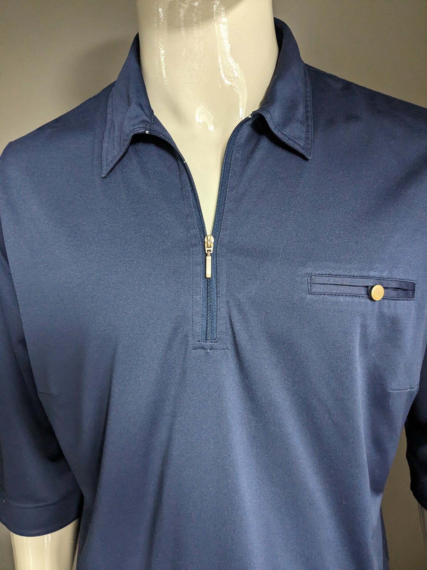 Vintage polo with elastic band and zipper and 3/4th sleeves. Dark blue colored. Size XL.
