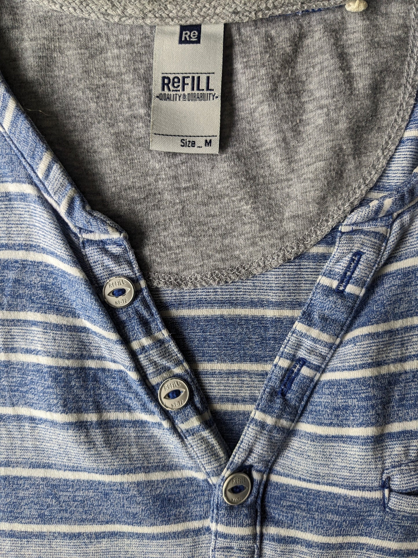 Refill shirt with V-neck and buttons. Blue white striped. Size M.