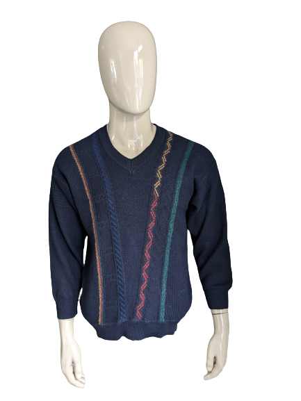 Vintage Maselli Wollpullover mit V-Ausschnitt. Dunkelblau mit gelb-rot-grün-blauem Motiv. Größe L.