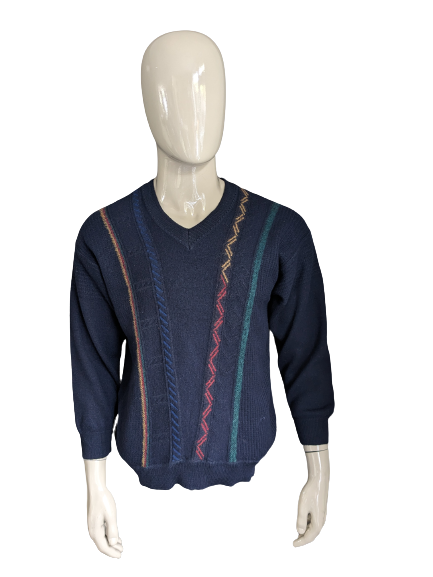 Suéter de lana Maselli Vintage con cuello en V. Azul oscuro con motivo de azul verde rojo amarillo. Talla L.