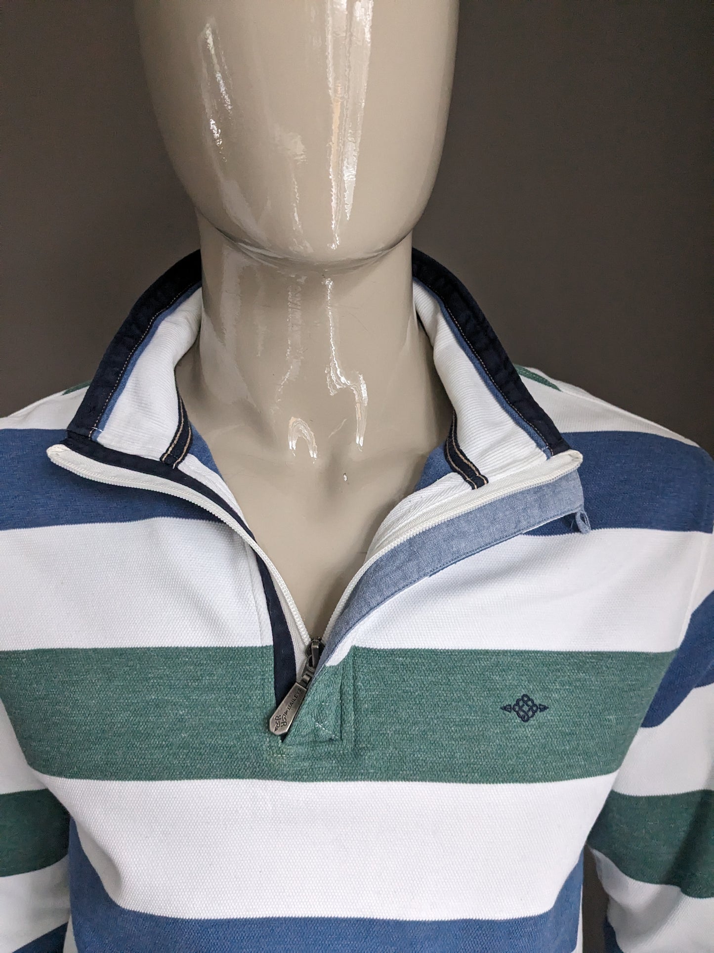 Pull Baileys avec fermeture éclair. Rayé bleu vert blanc. Taille XL.