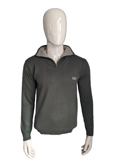 Pull de la Compagnie CSC avec fermeture éclair. De couleur vert foncé. Taille M.