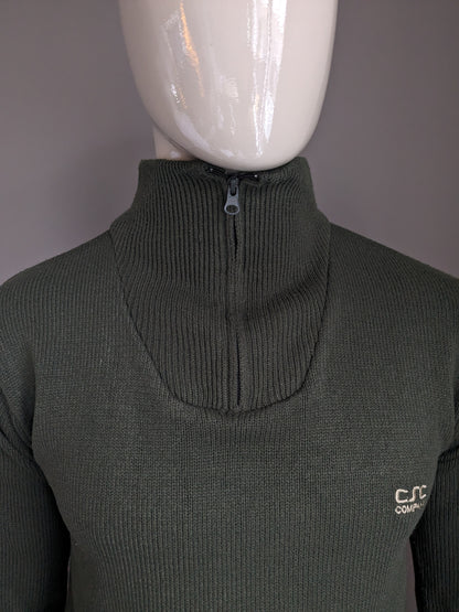 Pull de la Compagnie CSC avec fermeture éclair. De couleur vert foncé. Taille M.