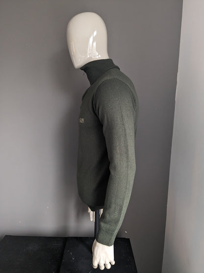 Pull de la Compagnie CSC avec fermeture éclair. De couleur vert foncé. Taille M.