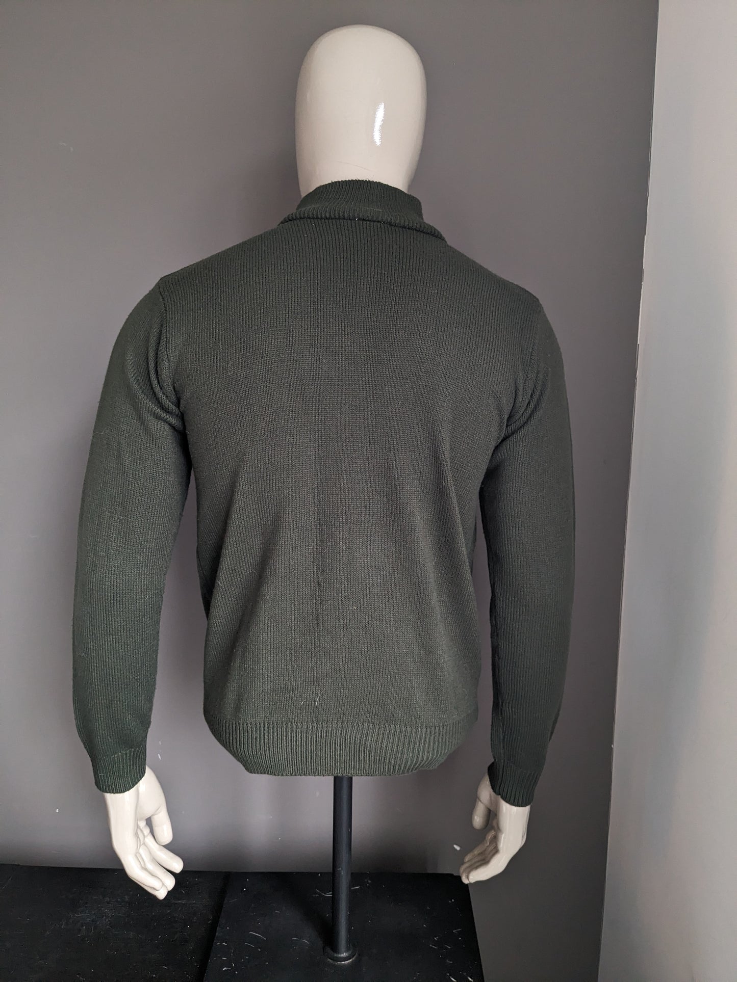 Pull de la Compagnie CSC avec fermeture éclair. De couleur vert foncé. Taille M.