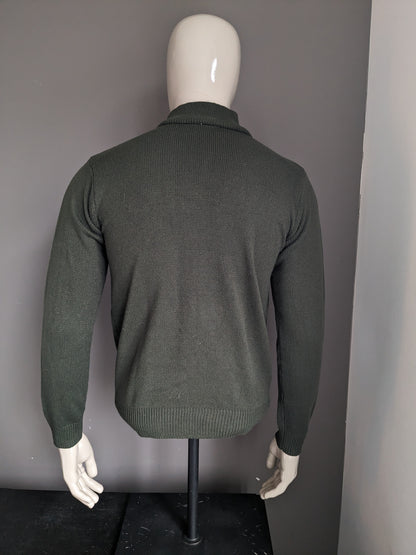 Pull de la Compagnie CSC avec fermeture éclair. De couleur vert foncé. Taille M.