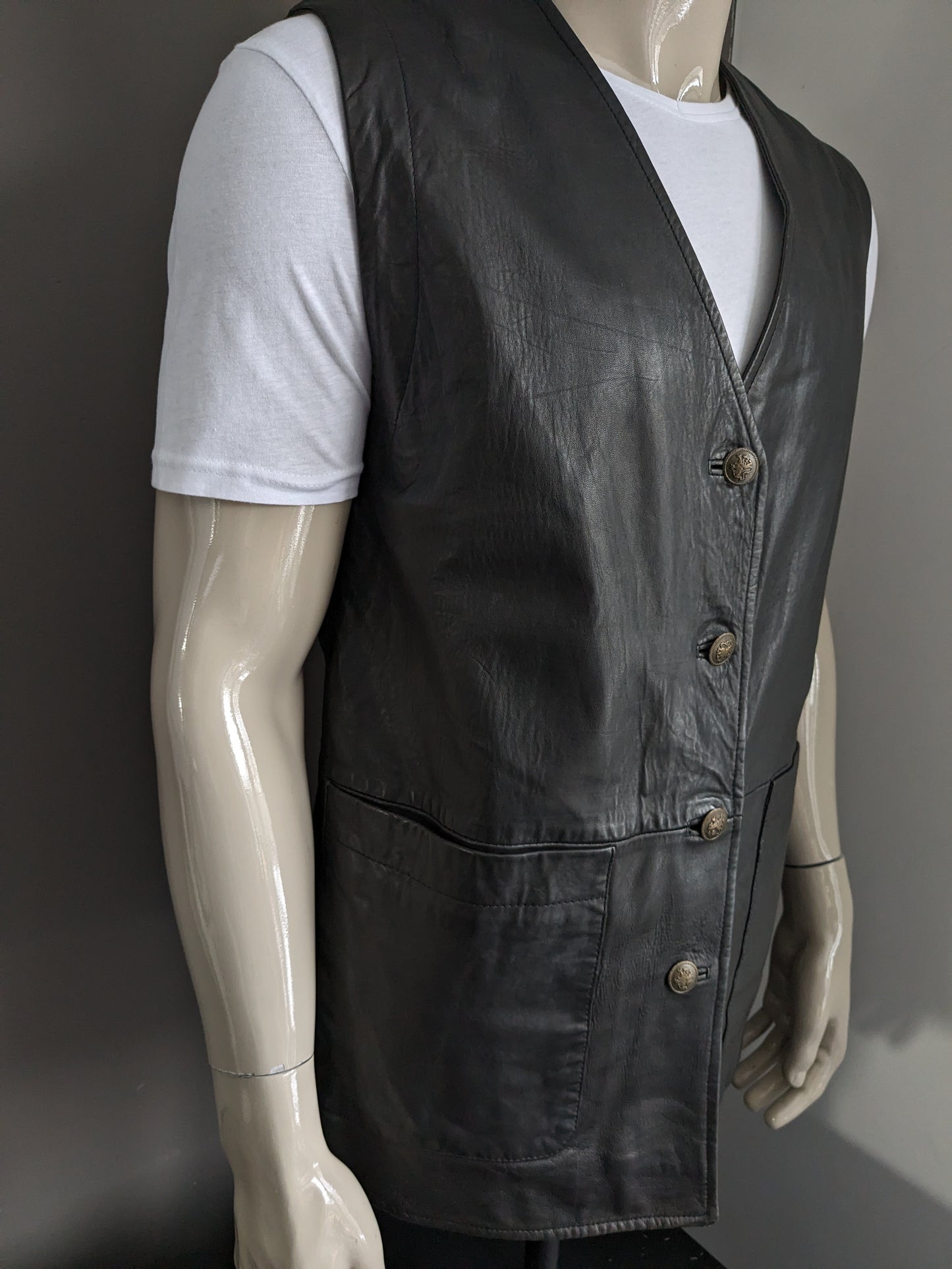 Medium length double -sided leather waistcoat with beautiful buttons. Dark brown. Size L.
