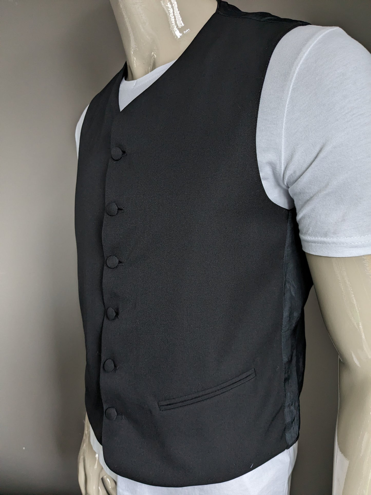 Gilet with upholstered buttons. Black colored. Size M. #337.