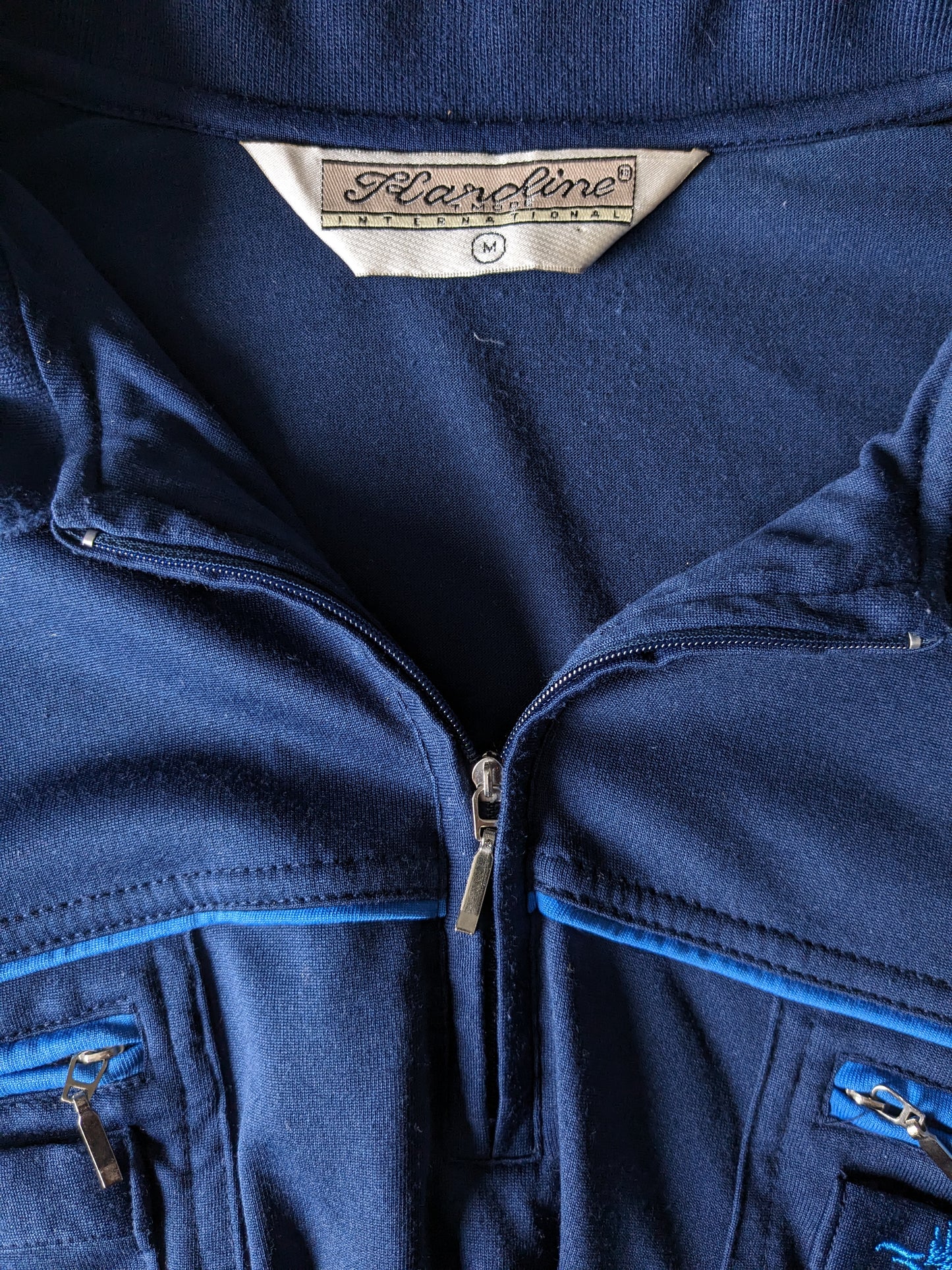 Vintage hardline polo with elastic band and zipper. Dark blue. Size M / L.