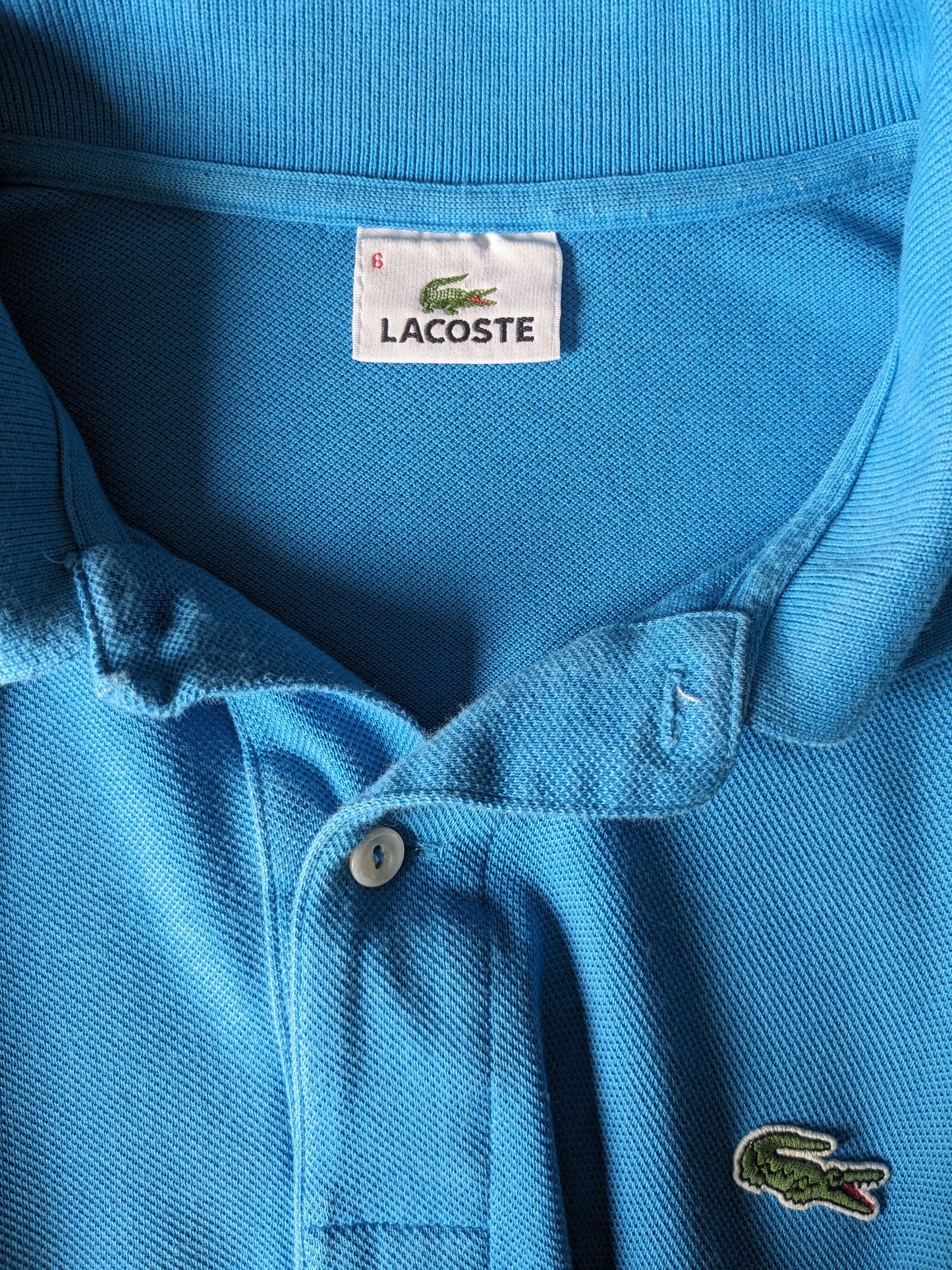 Lacoste Polo. Blue colored. Size 6 - XL.