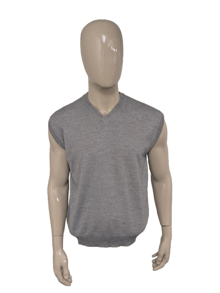 Spencer en laine de défilé. De couleur gris clair. Taille L. 50% Laine.