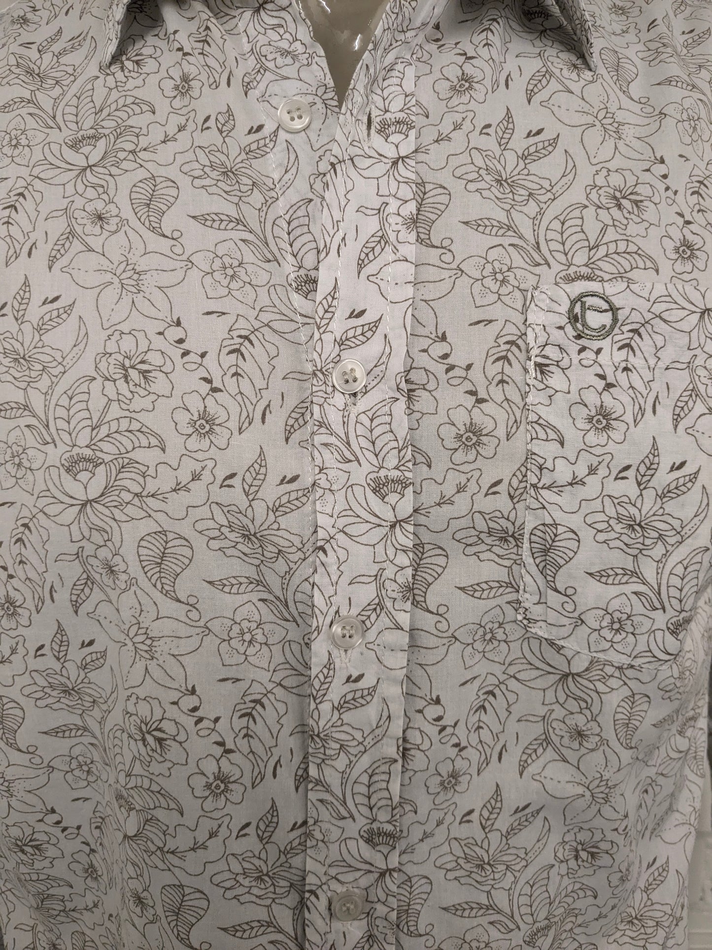 Simpugi di semplicità della maglietta beige marrone floreale. Taglia M.