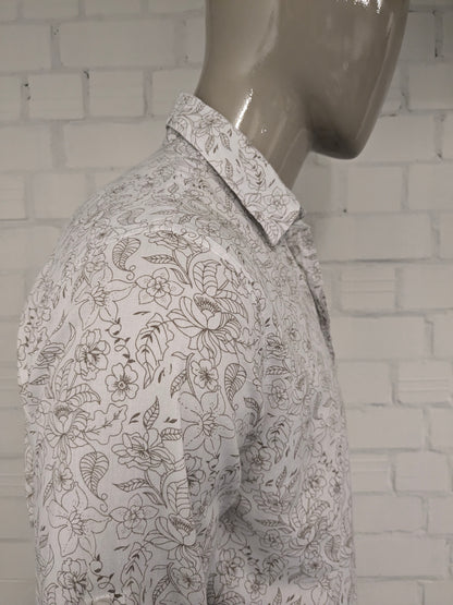 Simpugi di semplicità della maglietta beige marrone floreale. Taglia M.