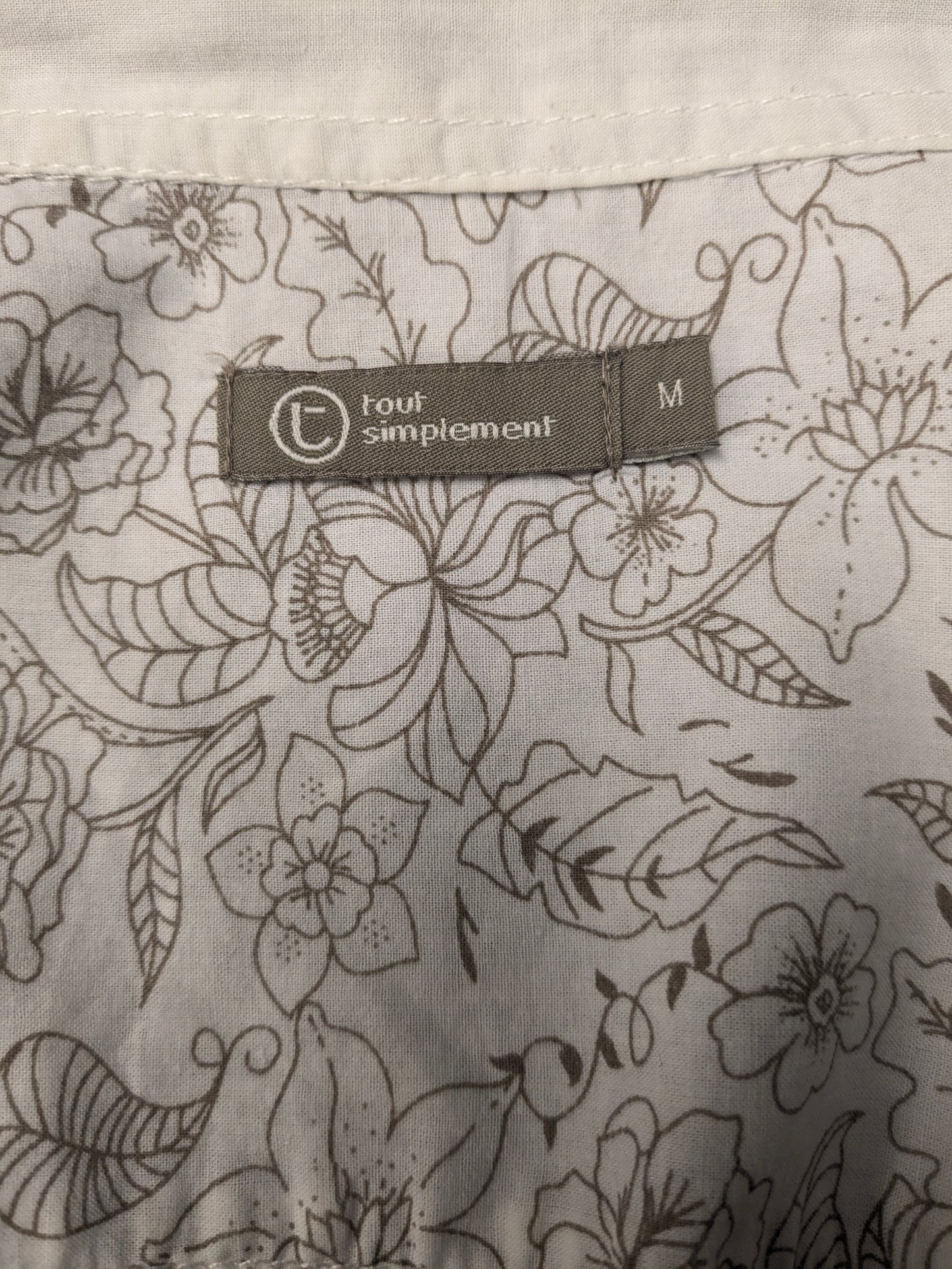 Simpugi di semplicità della maglietta beige marrone floreale. Taglia M.