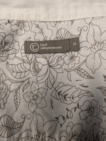 Simpugi di semplicità della maglietta beige marrone floreale. Taglia M.