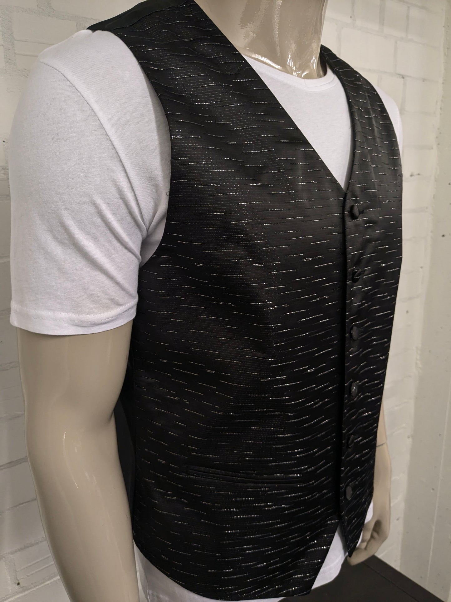 Black n white waistcoat. Black silver -colored shiny motif. Size L.