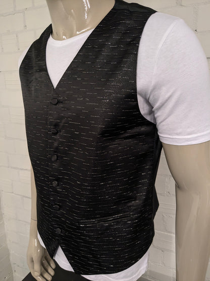 Black n white waistcoat. Black silver -colored shiny motif. Size L.