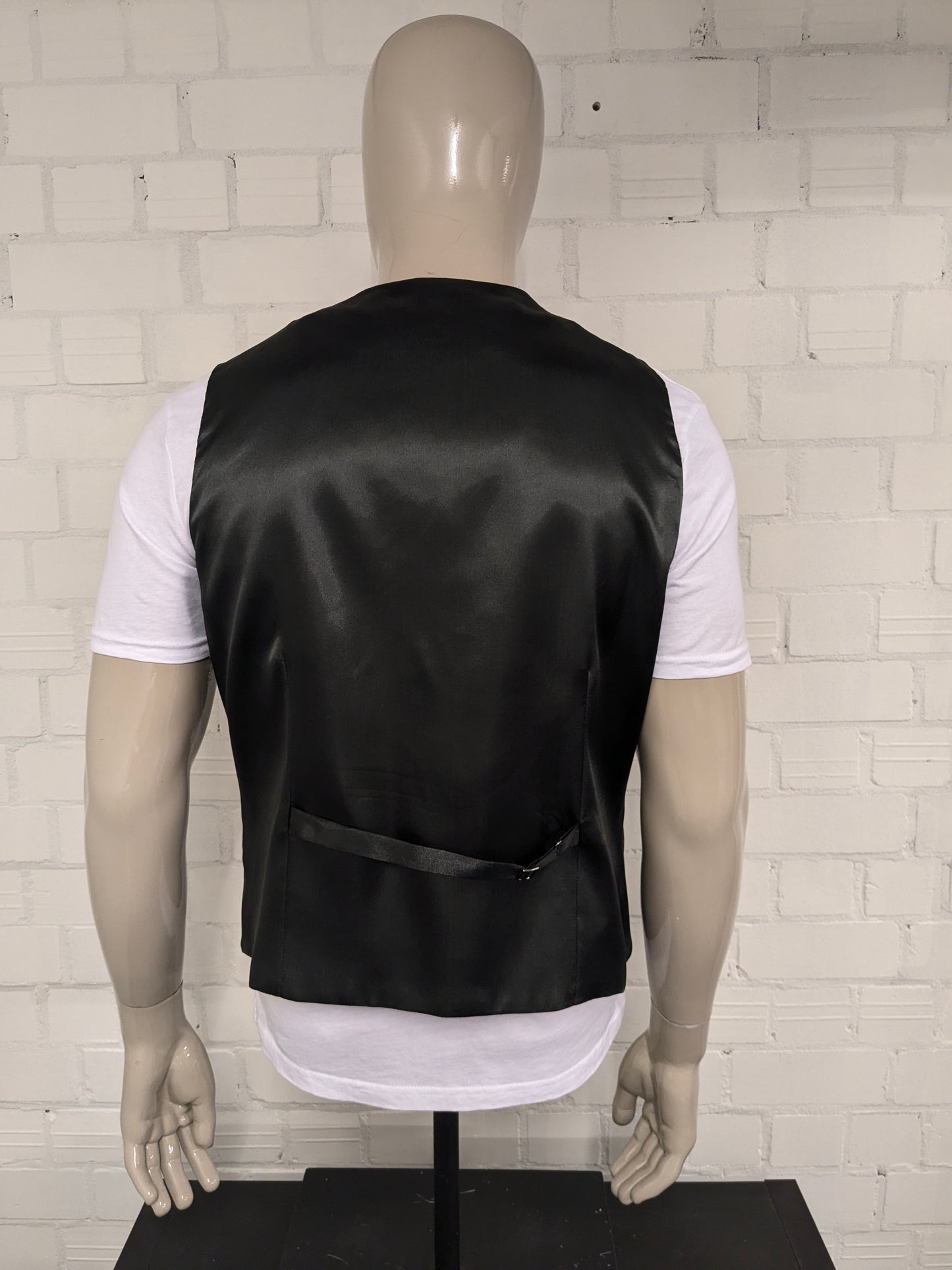 Black n white waistcoat. Black silver -colored shiny motif. Size L.