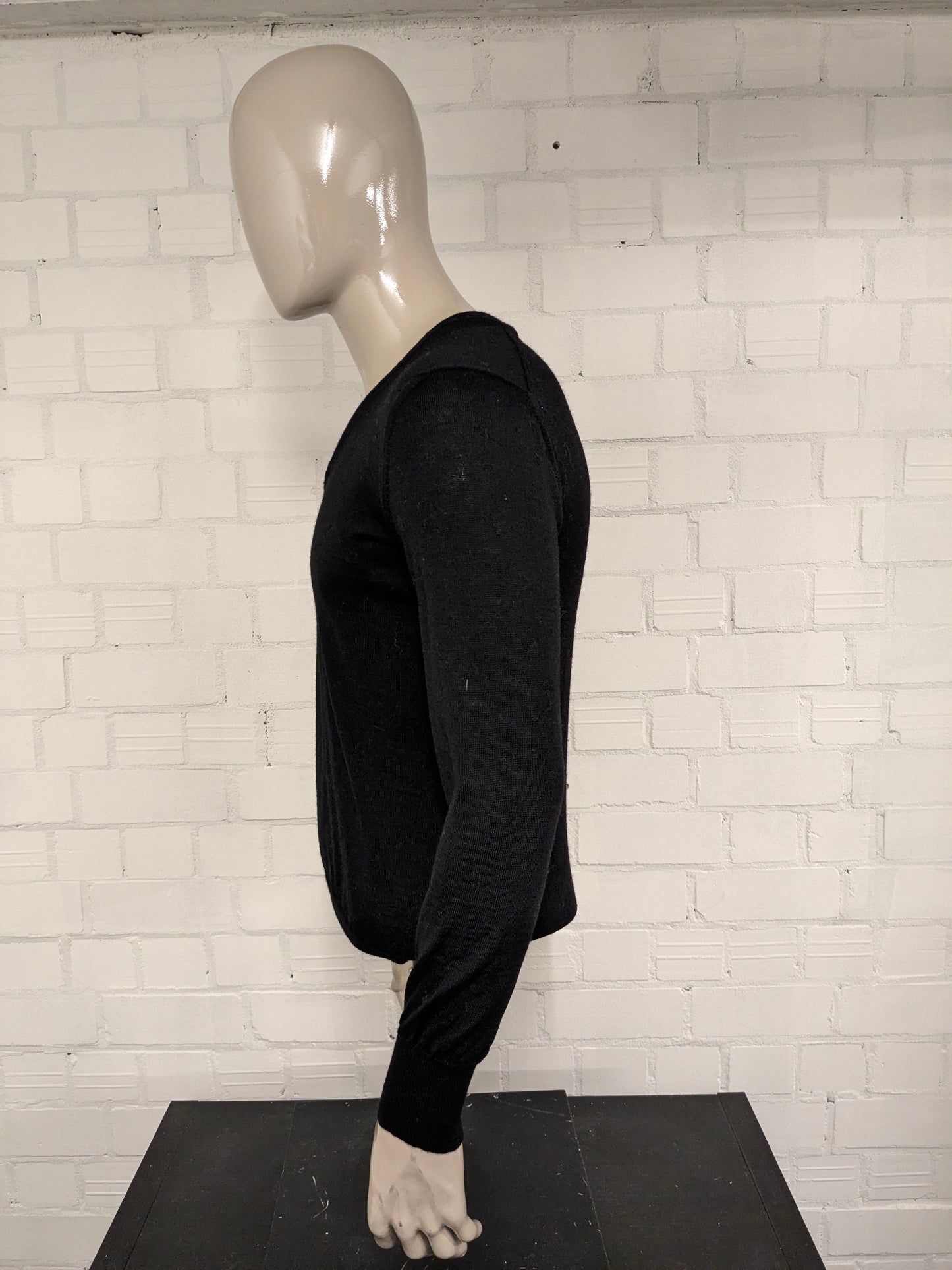 Top Man Woolen sweater with V-neck. Colored black. Size M. 100% Wool.