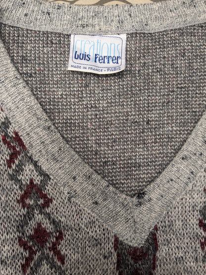 Maglione vintage Luis Ferrer in lana con scollo a V. Colore grigio rosso. Taglia L. 13% Lana.