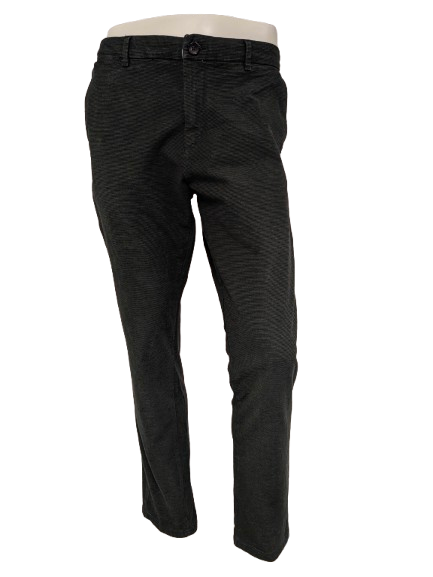 WE Fashion Hosen / Hosen. Grün Schwarz gestreift. Größe B34 - L34. strecken.