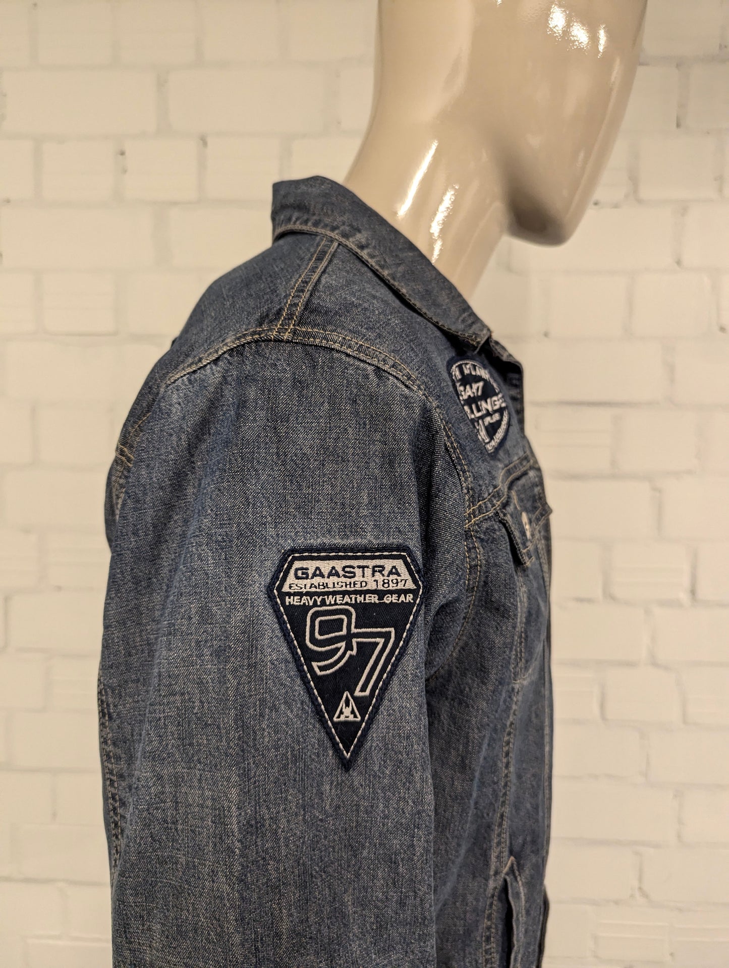 Gaastra spijker jack. Blauw gemêleerd met emblemen. Maat L.