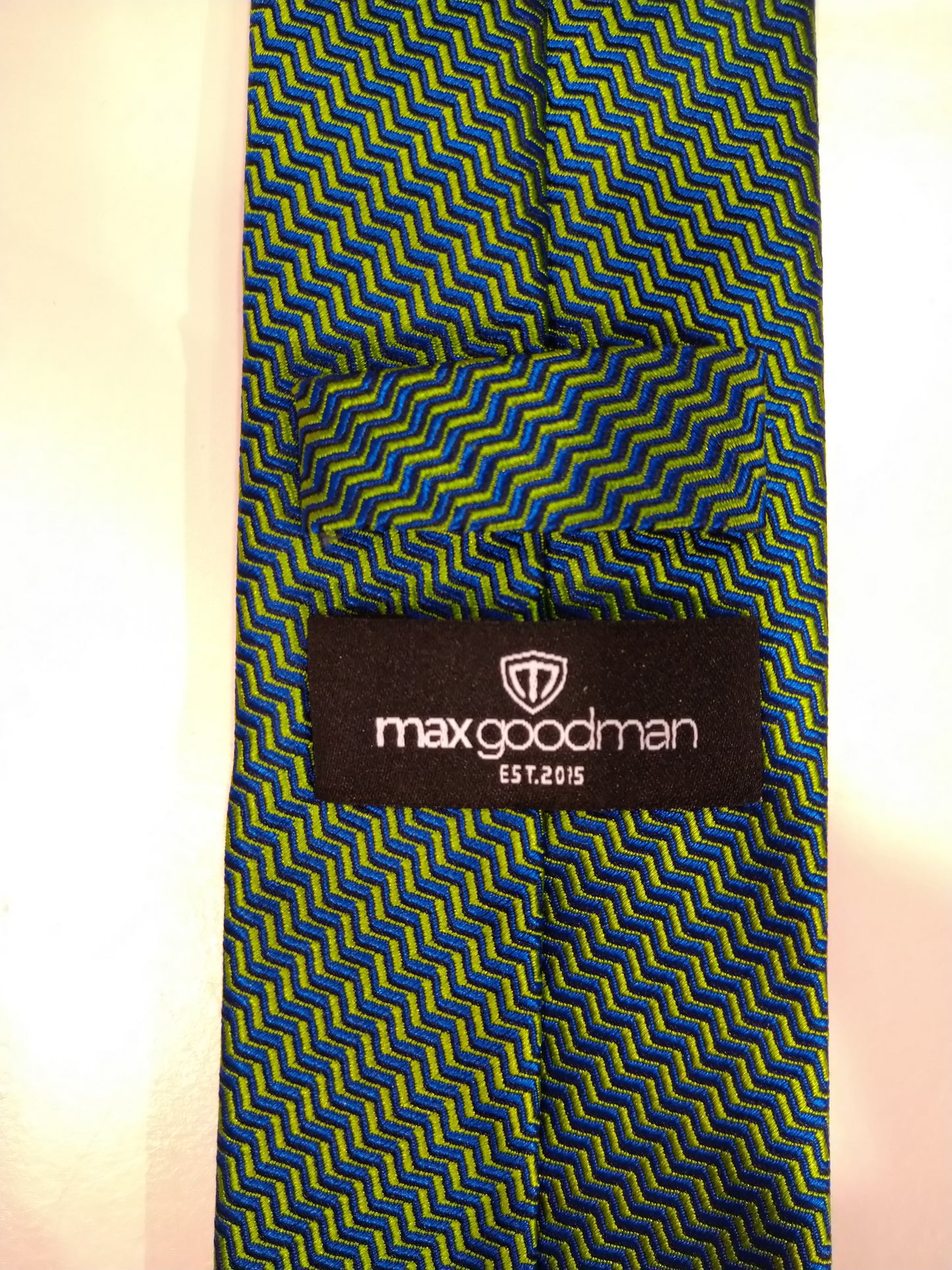 Max Goodman silk tie. Green with yellow motif.