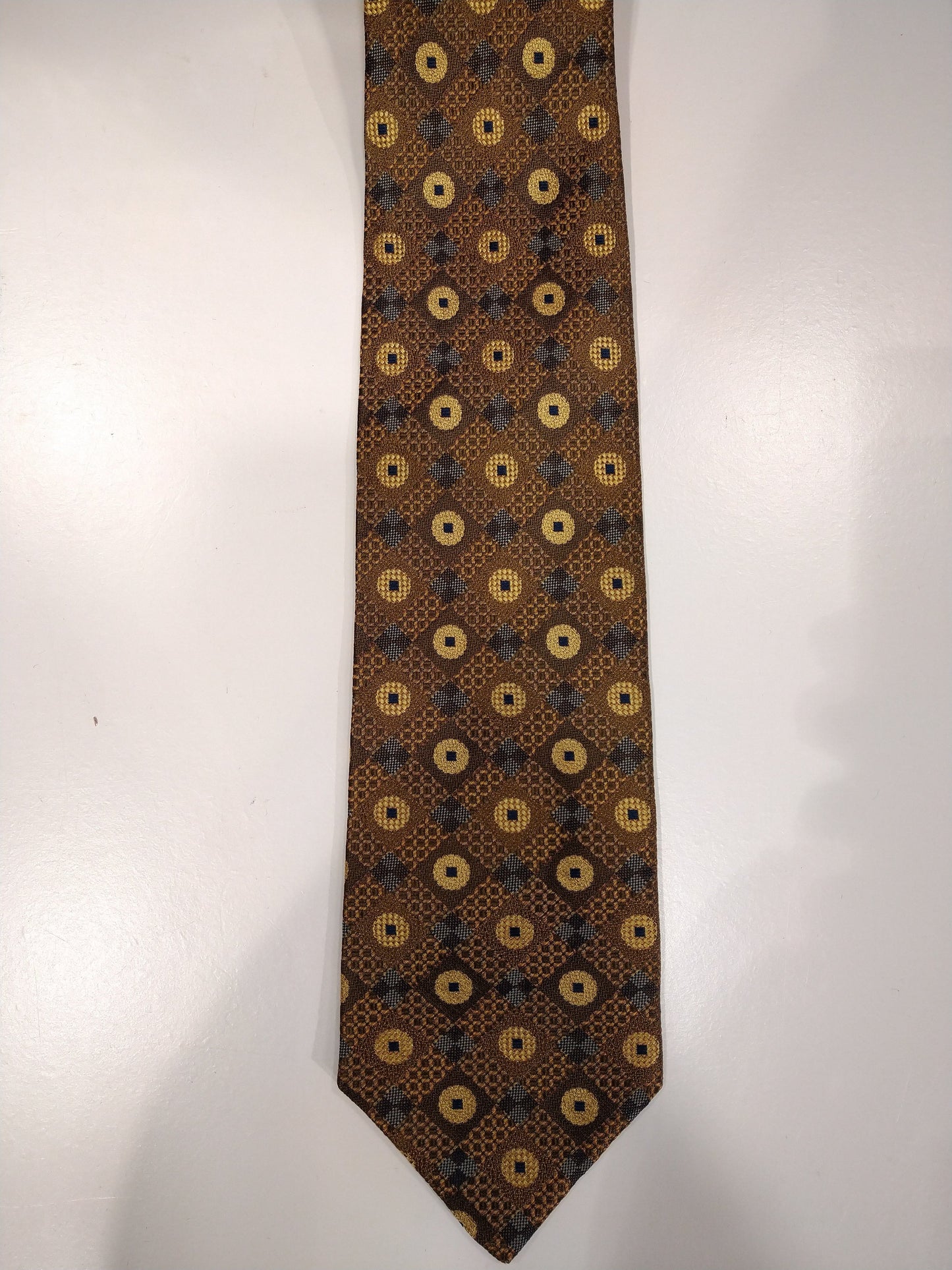 Michaelis zijde stropdas. Geel bruin goud grijs motief.