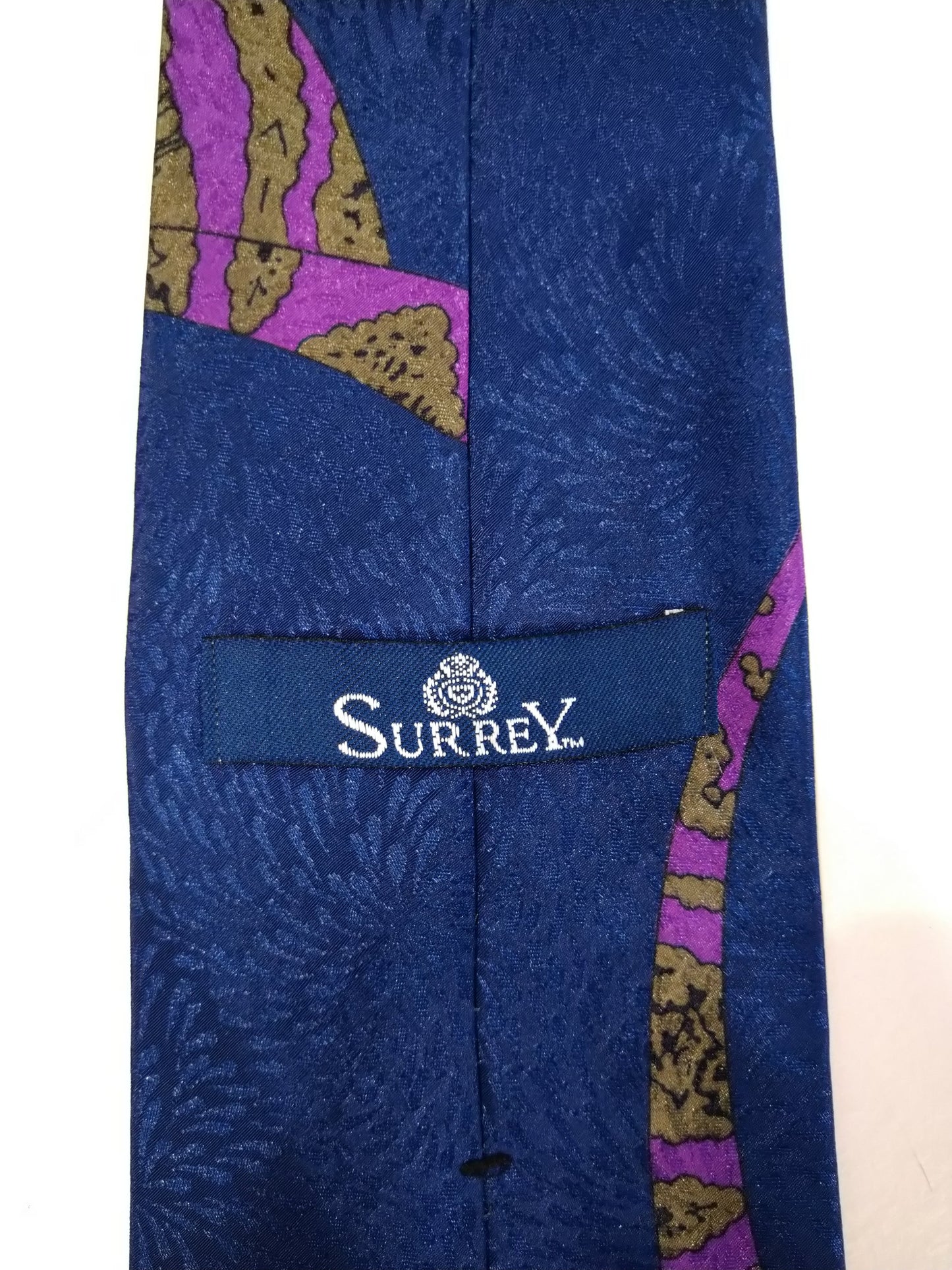 Surrey polyester tie. Separate blue purple motif.