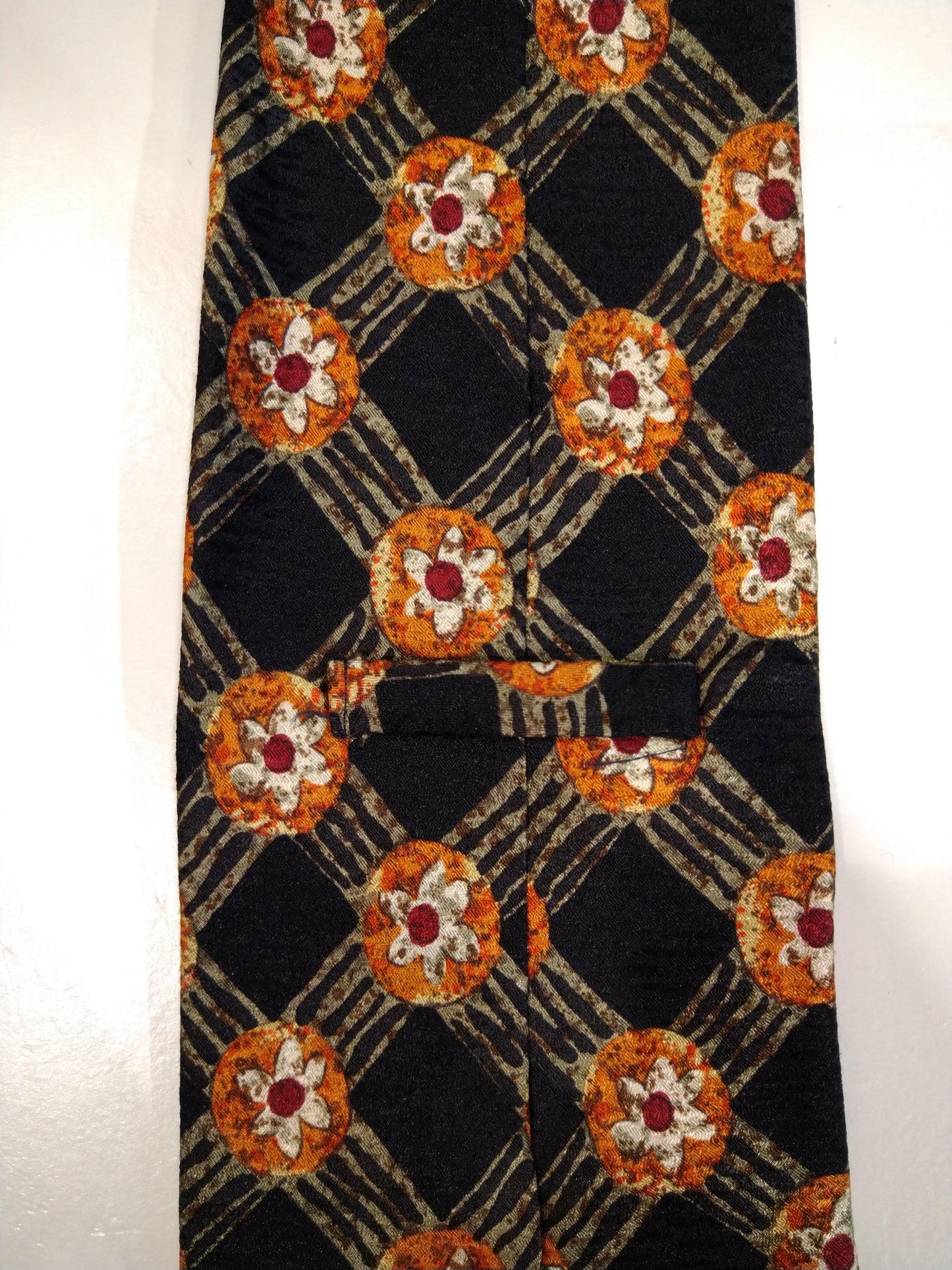 Silk tie. Black orange motif.