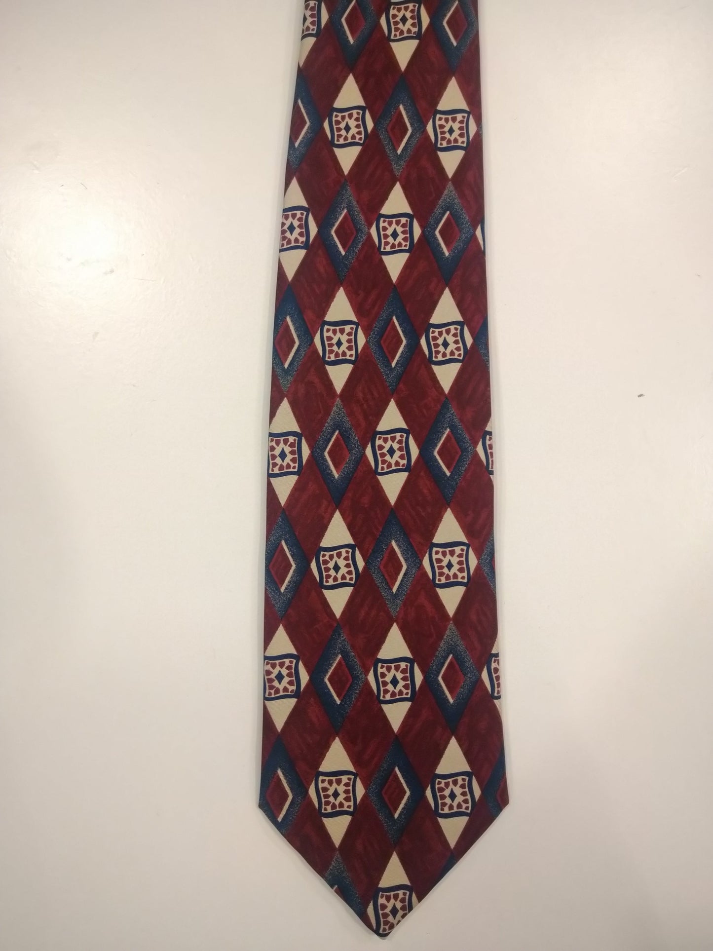 Burton's silk tie. Red blue beige motif.