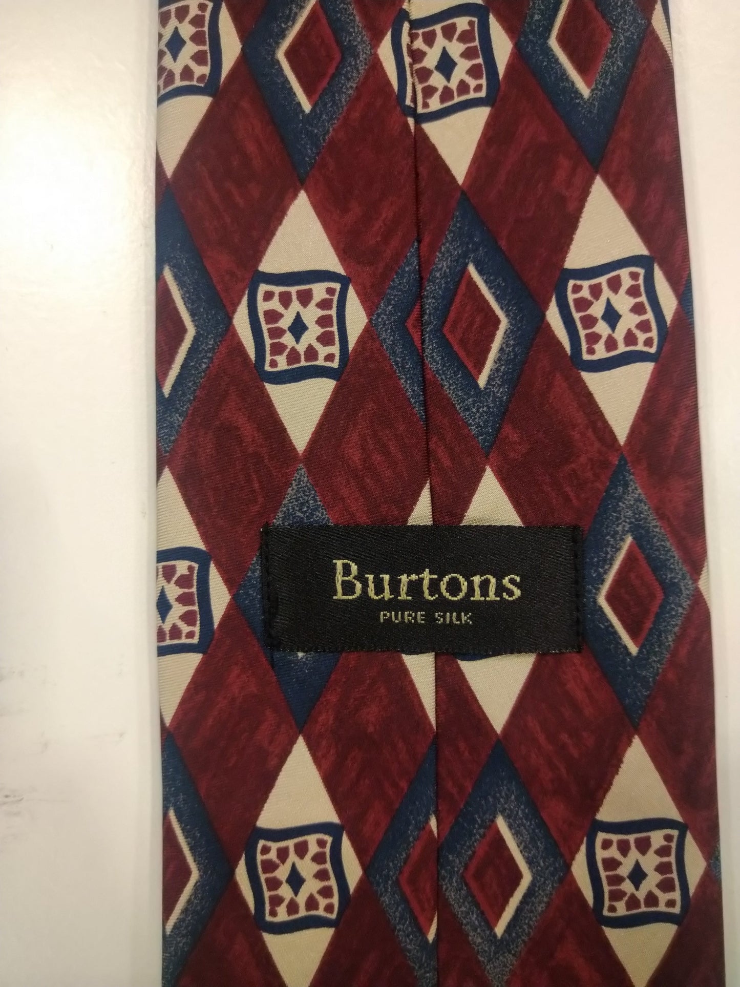 Burton's silk tie. Red blue beige motif.
