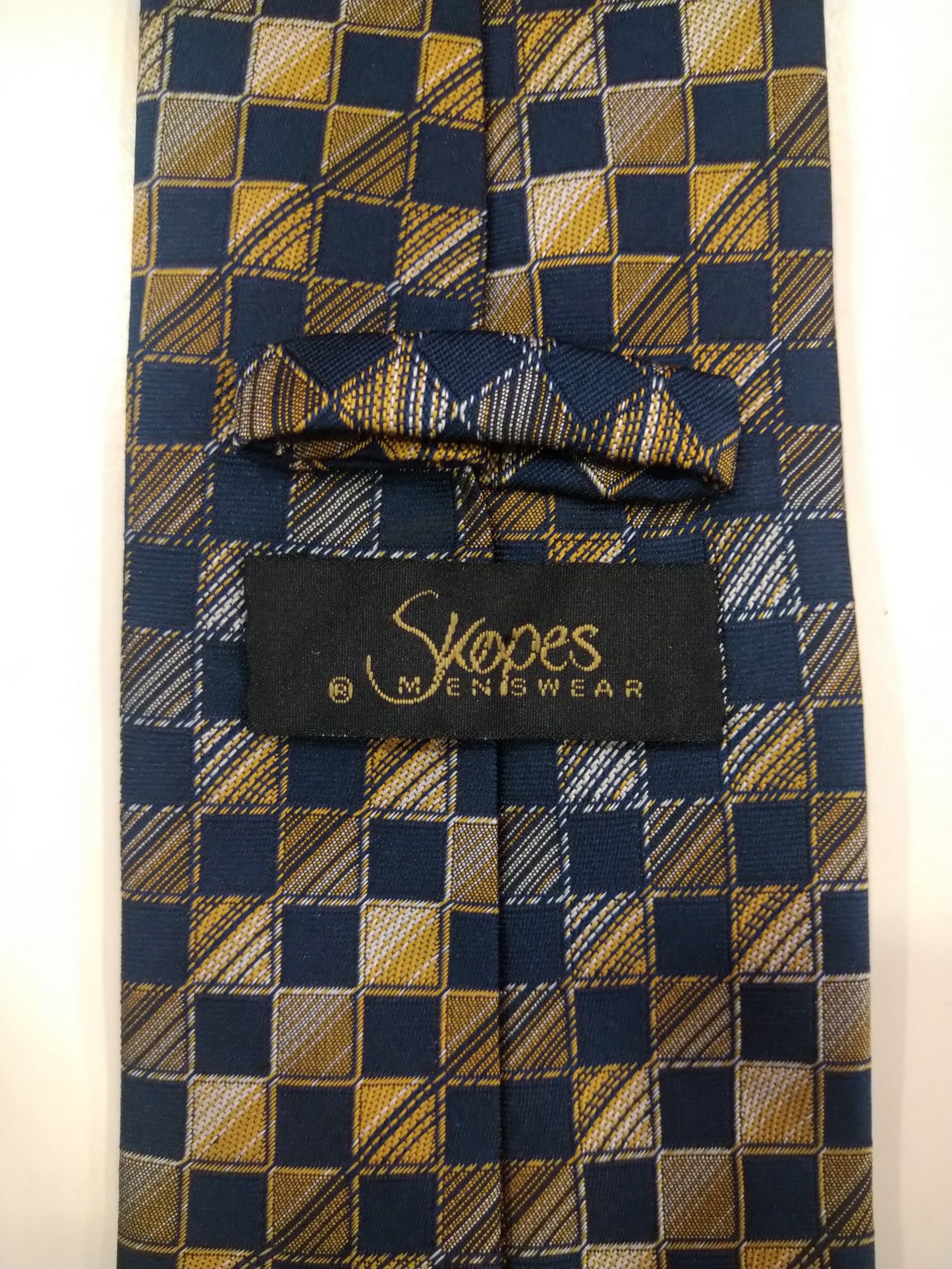 Skopes polyester tie. Separate blue gray yellow motif.