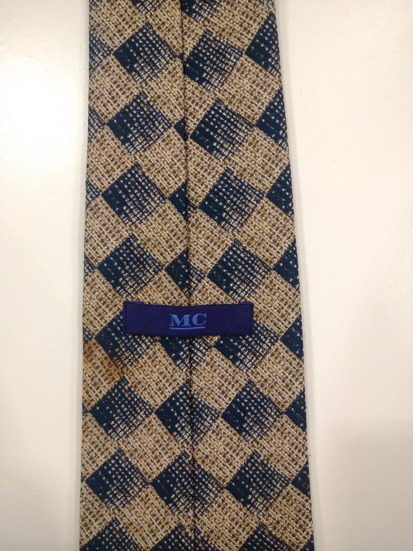 MC zachte polyester stropdas. Blauw beige motief.