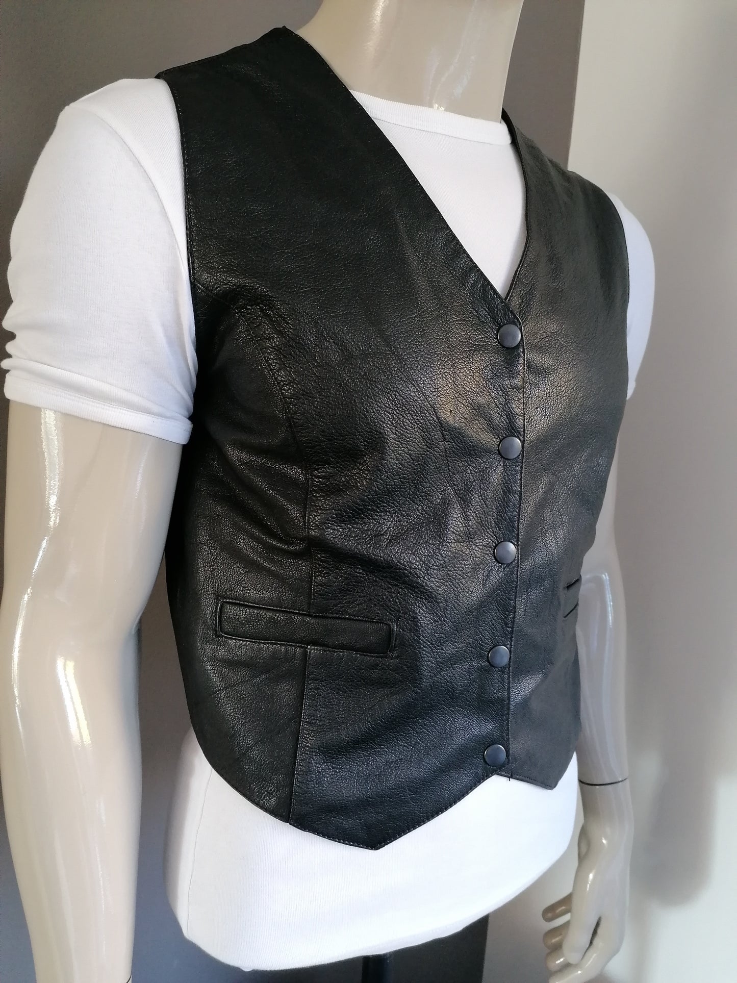 Leather waistcoat with press studs. Colored black. Size M. # 253