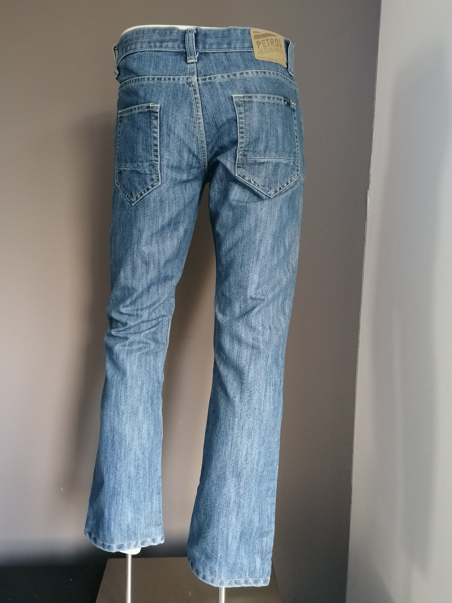 Petrol jeans. Colored blue. Size W32 - 30. Pants have been shortened.