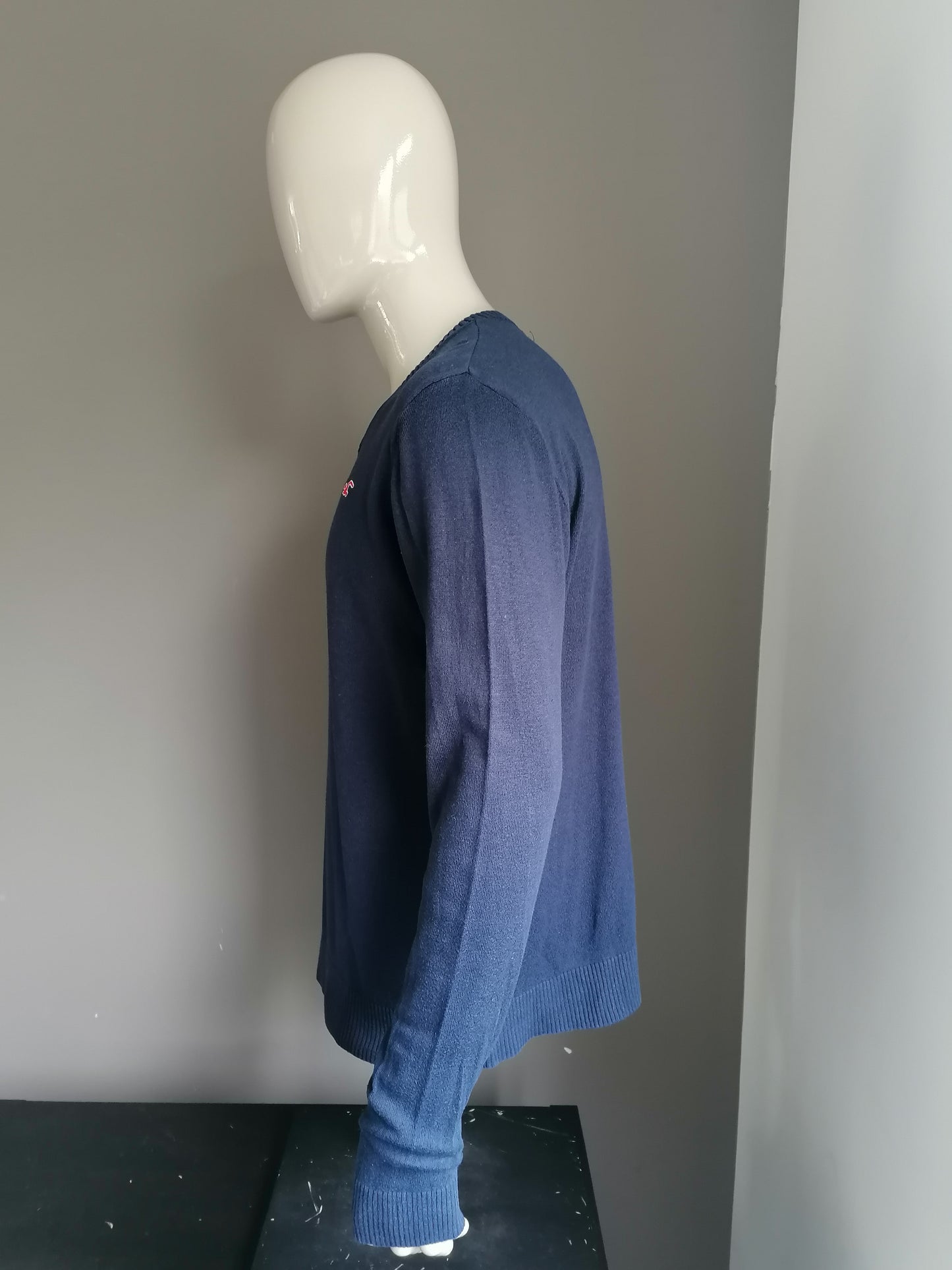Hollister sweater with V-neck. Dark blue colored. Size XL.
