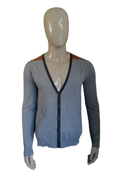 We fashion cardigan with buttons. Gray brown colored. Size M.