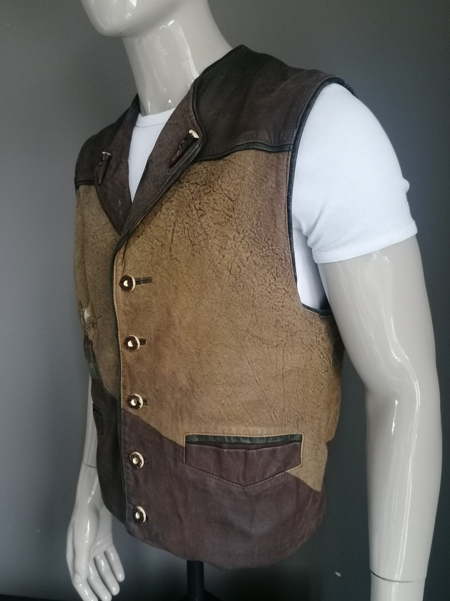 Solo who tries leather waistcoat with beautiful buttons. Brown with embroidery accents front and back. Size L.