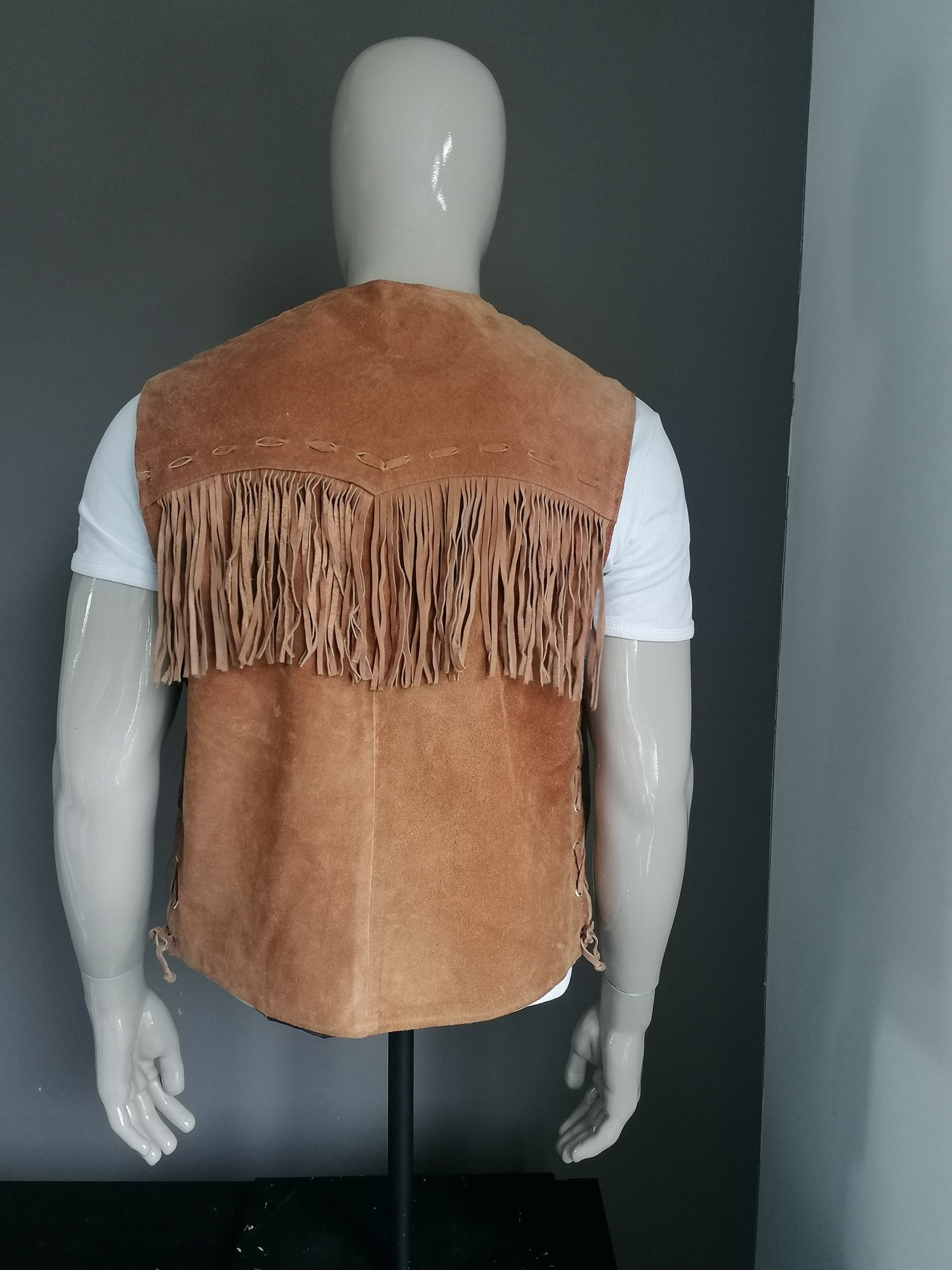 C. County leather suede waistcoat with fringes and press studs and veter accents side. Brown colored. Size L.