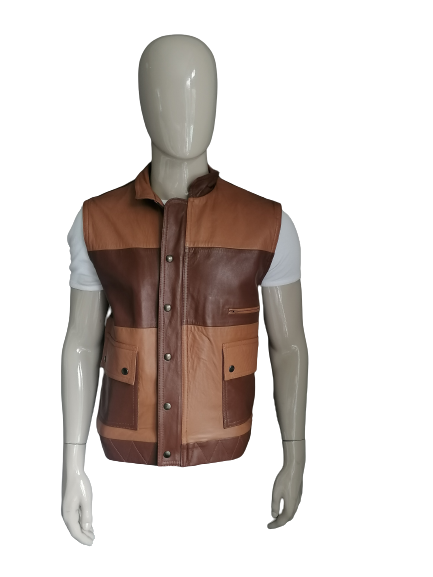Magnifique chauffe-corps en cuir. Zones brunes et double fermeture. Taille L. 1 poche intérieure.