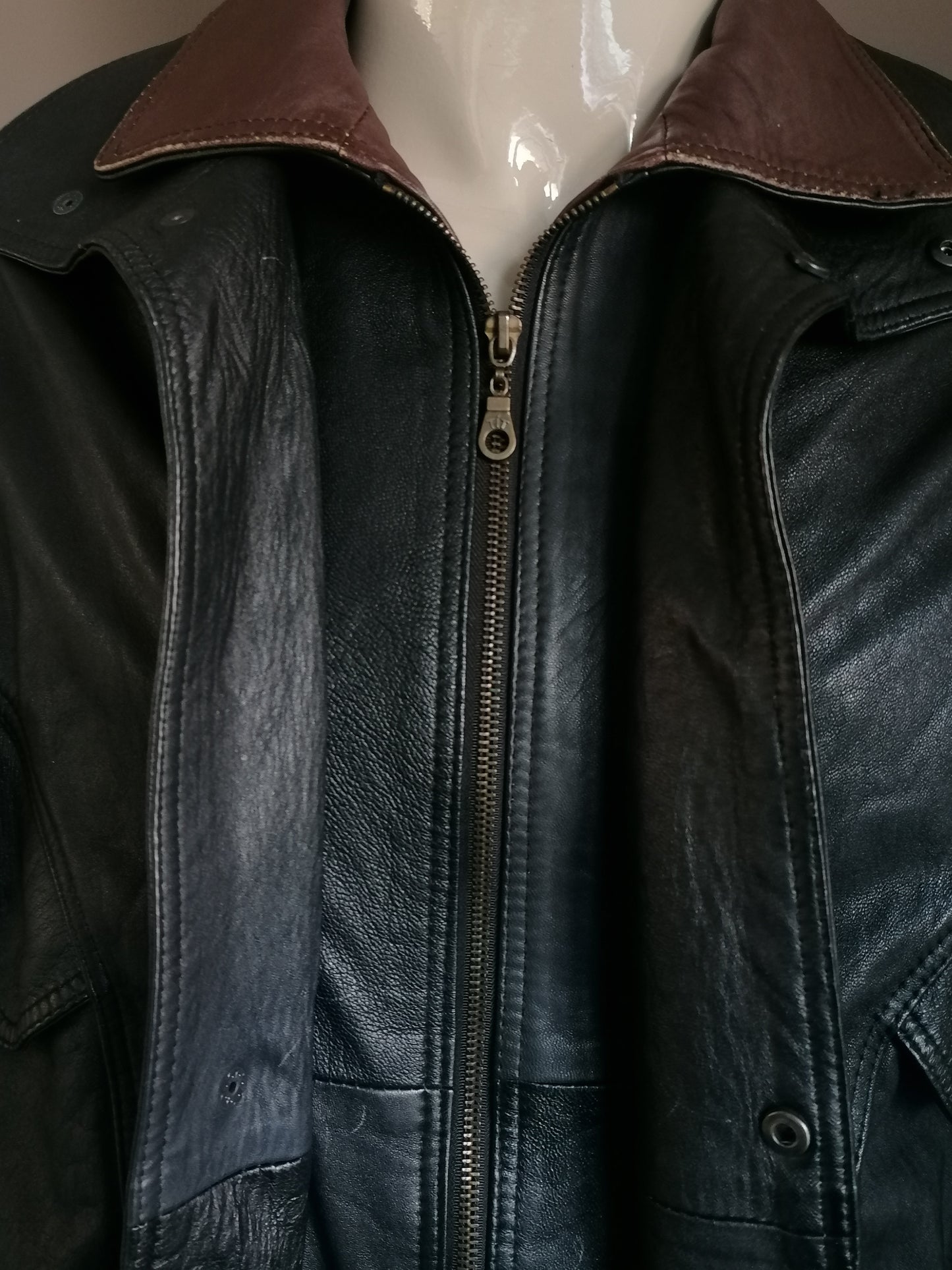 Vintage 80s-90s leather jacket with double closure. Brown black colored. Size L / XL.